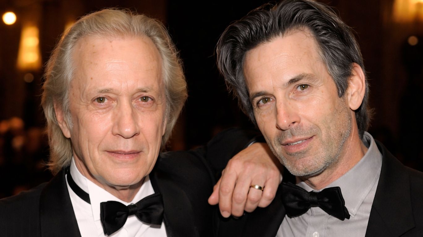 Carradine brothers in tuxedos with bow ties pose for a photo, one with a hand on the other's shoulder.